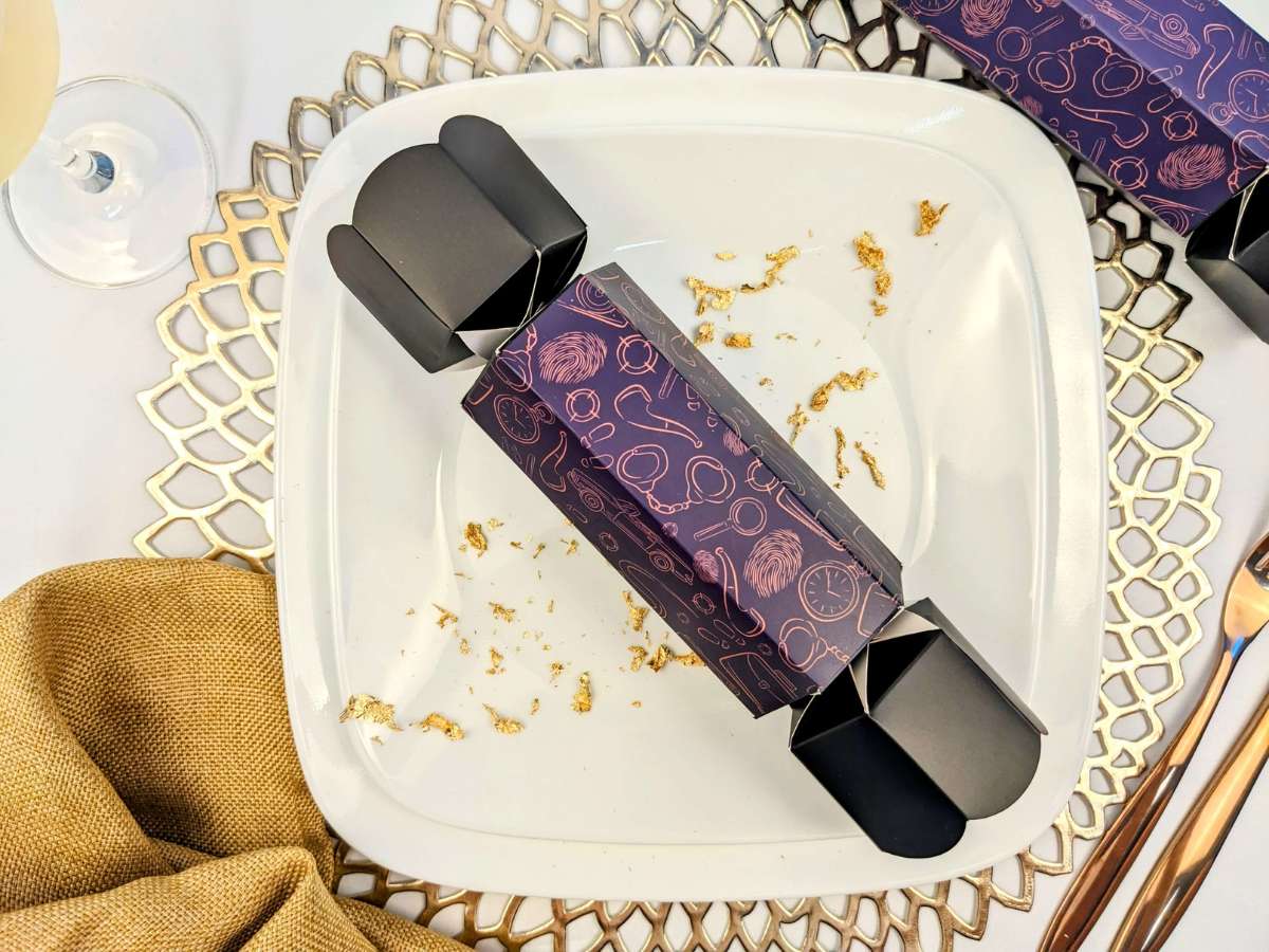 blue christmas cracker on white table setting