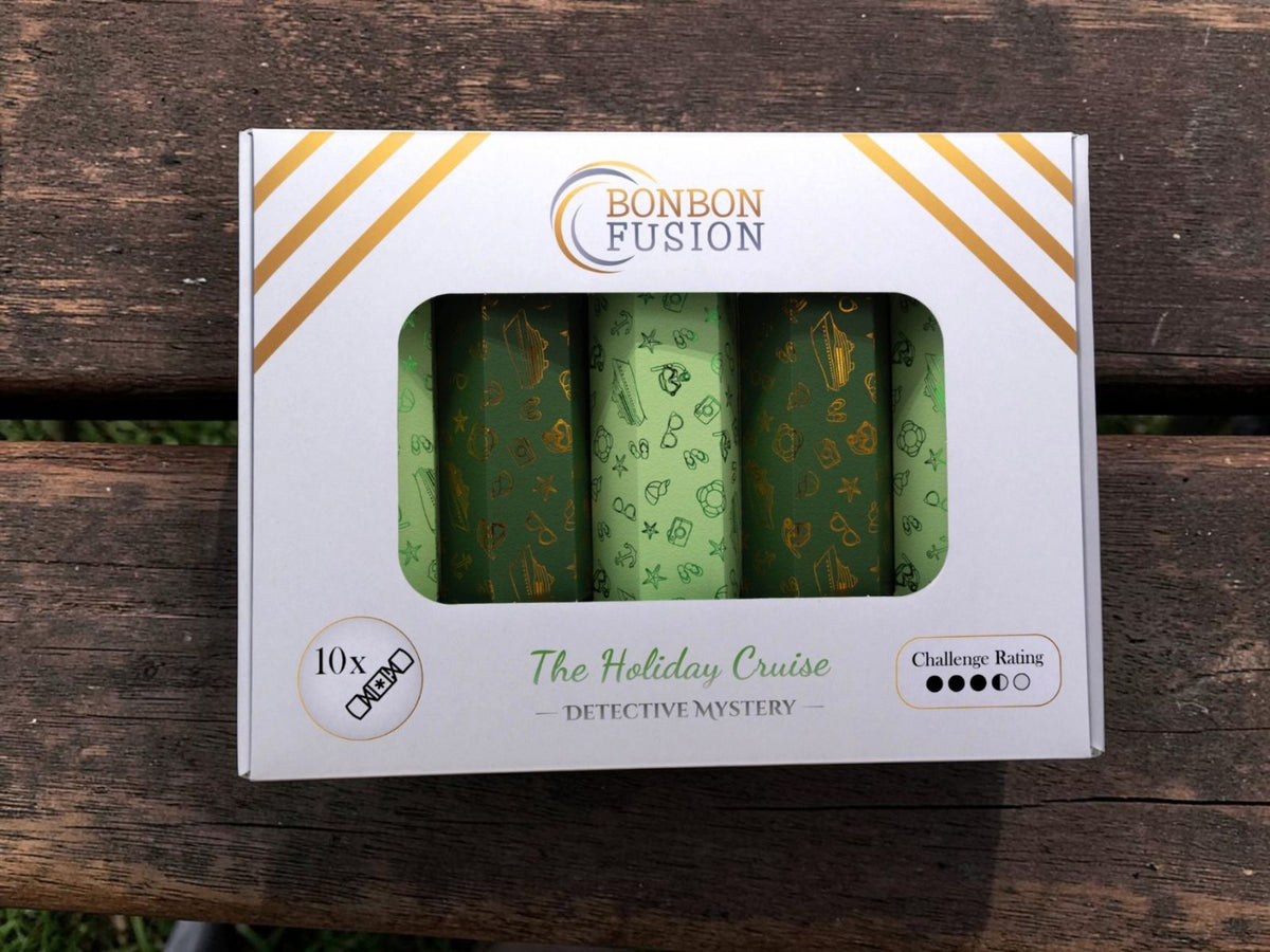 Bonbon Fusion Holiday Cruise Detective Mystery pack of 10 Christmas bonbons, with green and gold nautical designs, on a wooden bench.
