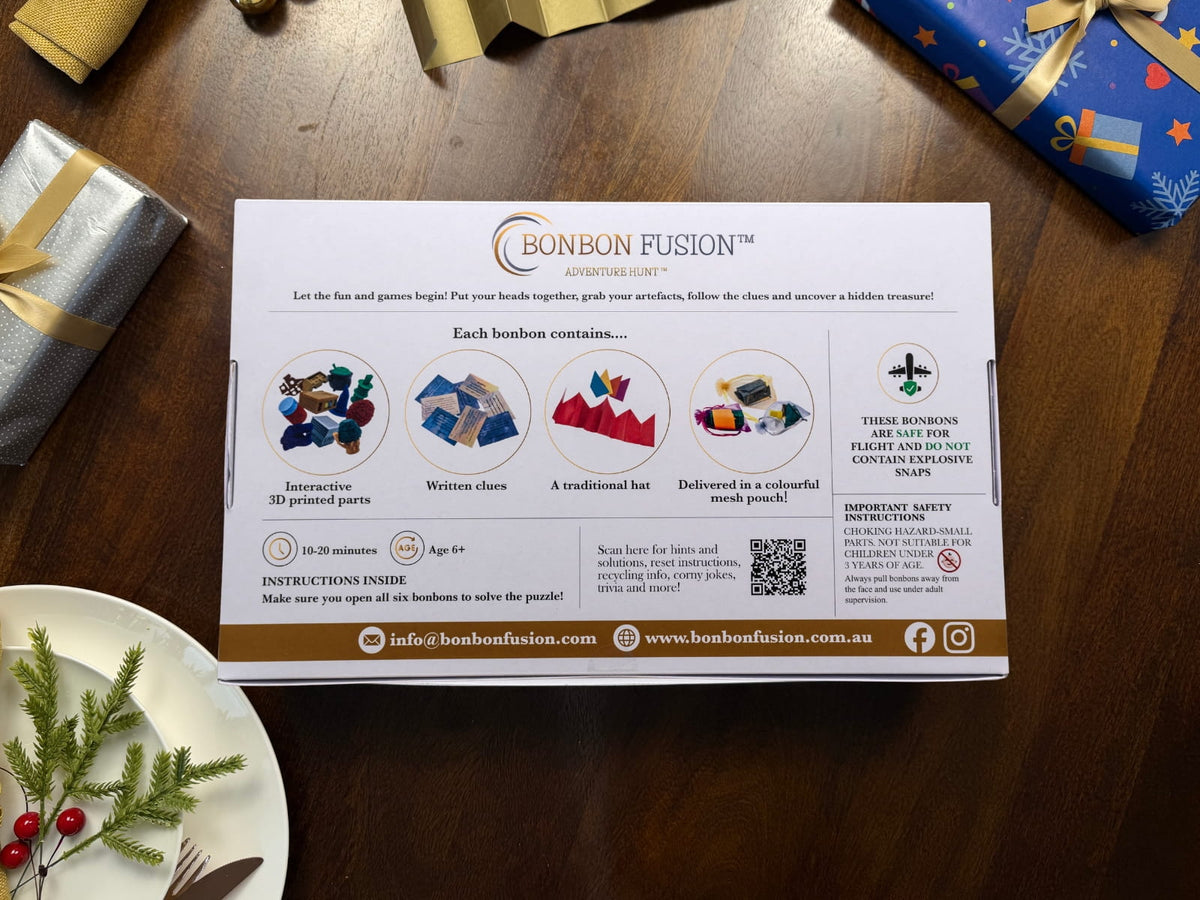 Back of Bonbon Fusion’s North Pole Adventure Hunt box, showing bonbon contents, ages 6+, 10–20 minutes playtime, safety information and a QR code, on a festive wooden table.
